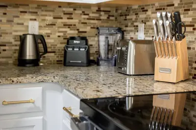 a kitchen with a counter top with utensils at Family 4br House w Pool near to Disney Much More in Kissimmee