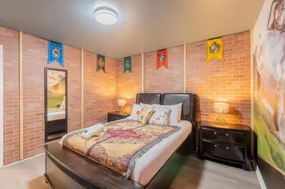 a bedroom with a bed and a brick wall at Family 4br House w Pool near to Disney Much More in Kissimmee