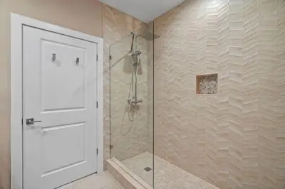a bathroom with a shower with a glass door at 3 Bedroom 4 Bathroom Magic Village 3099 in Orlando
