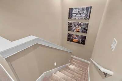 a staircase with a picture on the wall at 3 Bedroom 4 Bathroom Magic Village 3099 in Orlando