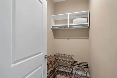 a room with a closet with a chair and a door at 3 Bedroom 4 Bathroom Magic Village 3099 in Orlando
