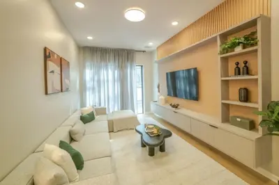 a living room with a white couch and a tv at 5 Bedroom 5 Bathroom Paradiso Grande 10352 in Orlando