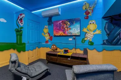 a room with a blue wall with cartoons on it at Magical 6BR Family Retreat with Pool Near Disney in Orlando