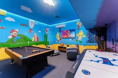 a kids room with a ping pong table in it at Magical 6BR Family Retreat with Pool Near Disney in Orlando