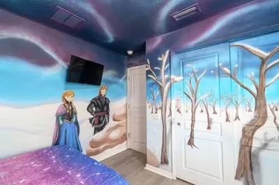 a bedroom with a painting of a winter scene at Magical 6BR Family Retreat with Pool Near Disney in Orlando