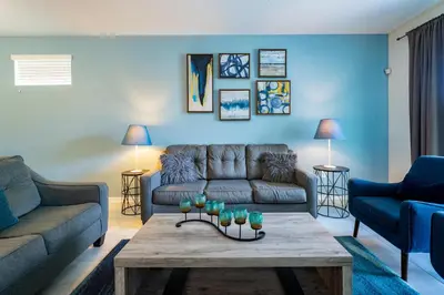 a living room with a couch and a table at Themed 3-bed 2 bath condo at Storey Lake Resort in Kissimmee