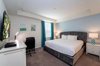a bedroom with a bed and a desk and a computer at Themed 3-bed 2 bath condo at Storey Lake Resort in Kissimmee