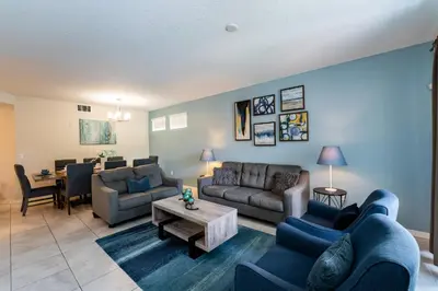 a living room with couches and a table at Themed 3-bed 2 bath condo at Storey Lake Resort in Kissimmee