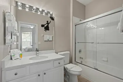 a bathroom with a toilet and a sink and a shower at Amazing House Amazing Amenities in Orlando
