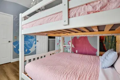 a bedroom with bunk beds with a pink bed at Windsor Hills Water Park Adventure Home in Orlando