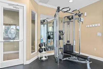 a fitness room with a gym with tread machines at Elegant Townhome w Water Park near Disney Parks in Orlando