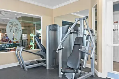 a gym with two tread machines and a mirror at Elegant Townhome w Water Park near Disney Parks in Orlando