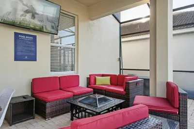 a waiting room with red chairs and a table at 6BR Fun in the Sun with FREE water park in Orlando