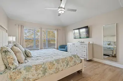 a bedroom with a bed and a dresser and a window at 6BR Fun in the Sun with FREE water park in Orlando