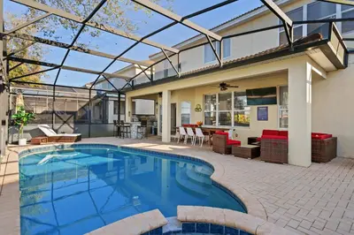 a swimming pool in a patio with a house at 6BR Fun in the Sun with FREE water park in Orlando