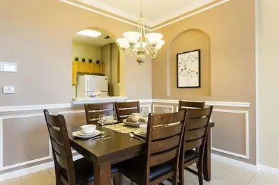 a dining room with a wooden table and chairs at Windsor Hills Condo: Water Park Included in Orlando