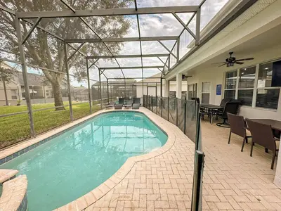 a swimming pool in a house with a patio at Family Fun 6BR Poolside w Water Park Game Room in Orlando