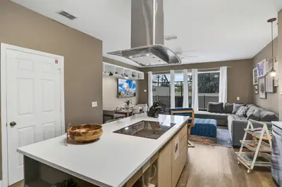 an open kitchen and living room with a couch at Water Park Haven: Spacious 3BR Windsor Hills in Orlando