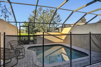 a swimming pool in a house with a glass ceiling at Water Park Haven: Spacious 3BR Windsor Hills in Orlando