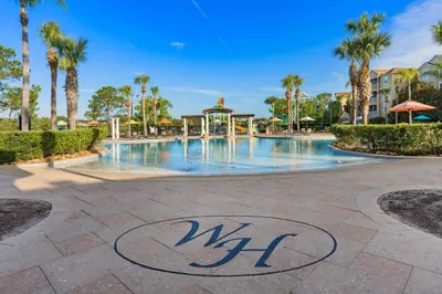 a swimming pool at a resort with palm trees at Water Park Haven: Spacious 3BR Windsor Hills in Orlando
