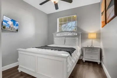 a bedroom with a white bed and a window at Elegant Getaway Windsor Hills Condo w Water Park in Orlando