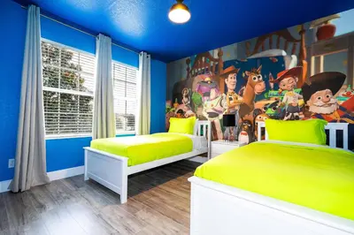 a bedroom with two beds and a mural of goofy at FREE Water Park Fun Included Large Resort Home in Orlando