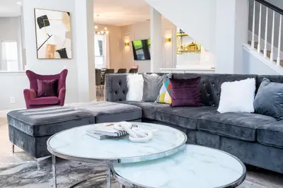 a living room with a couch and a table at FREE Water Park Fun Included Large Resort Home in Orlando