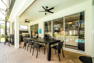 a dining room with a black table and chairs at Family-Friendly Villa Resort: Free Water Park in Orlando
