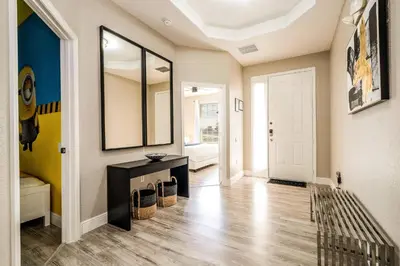 a hallway with a mirror and a black table at Family-Friendly Villa Resort: Free Water Park in Orlando