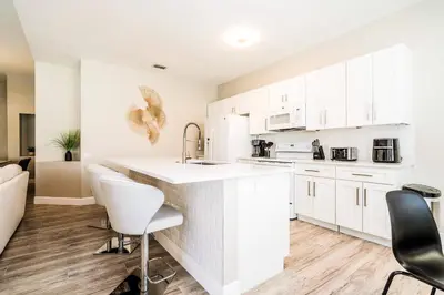 a kitchen with white cabinets and white appliances at Family-Friendly Villa Resort: Free Water Park in Orlando