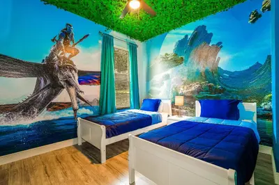 a bedroom with two beds and a painting of a mermaid at Family-Friendly Villa Resort: Free Water Park in Orlando