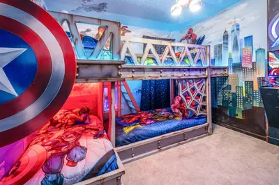 a bedroom with two bunk beds and a superhero mural at Luxury Meets Adventure 8BR Condo with Themed Rooms in Orlando