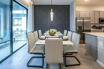 a kitchen and dining room with a table and chairs at Luxury Meets Adventure 8BR Condo with Themed Rooms in Orlando