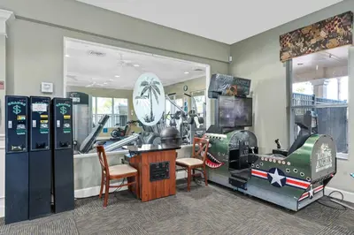 a room with a room with machines in it at Vacation Haven Windsor Hills Condo with Water Park in Orlando