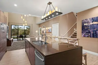 a kitchen with a sink and a counter top at Elegant Escape: 4BR Villa near Disney Views in Orlando