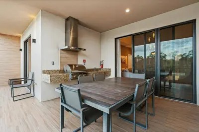 a kitchen and dining room with a wooden table and chairs at Elegant Escape: 4BR Villa near Disney Views in Orlando