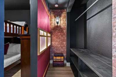 a room with two bunk beds and a brick wall at Group Getaway Paradise: Large Home Water Park in Orlando