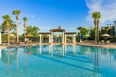 a pool at a resort with a gazebo and palm trees at Windsor Hills Getaway: Condo with Water Park in Orlando
