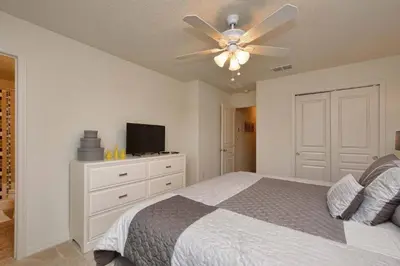 a bedroom with a bed and a ceiling fan at Family Paradise 4BR Compass Bay Townhome Sleeps 11 in Kissimmee