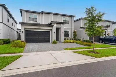 a large white house with a garage at Kids Dream Vac Home Harry Potter Mickey Rooms in Orlando