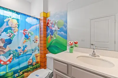 a bathroom with a toilet and a shower curtain at Kids Dream Vac Home Harry Potter Mickey Rooms in Orlando