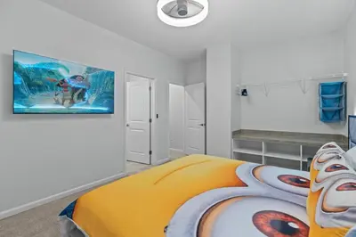 a bedroom with a bed and a painting on the wall at Unforgettable Vacation: 9BR Paradiso Grand Resort in Orlando