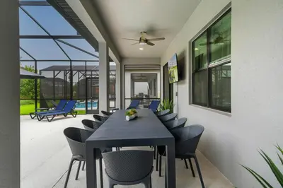 a dining room with a table and chairs at Paradiso Grand Resort 6 bedroom in Orlando