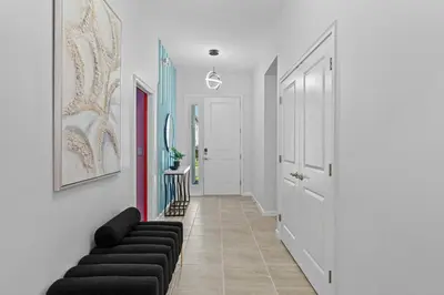 a hallway with black couches in a room at Luxury Living: 6BR Condo near SeaWorld ICON Park in Orlando