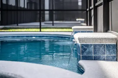 a swimming pool with a fountain in a building at Themed Retreat 6BR w Magical Rooms Private Pool in Orlando