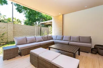 a patio with a couch and a table at Casa 3Q c/ Área de Churrasco – Próx. Disney in Orlando