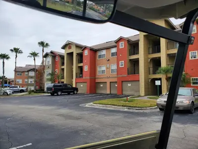 a view of a parking lot with some buildings at Villa del Sol in Kissimmee