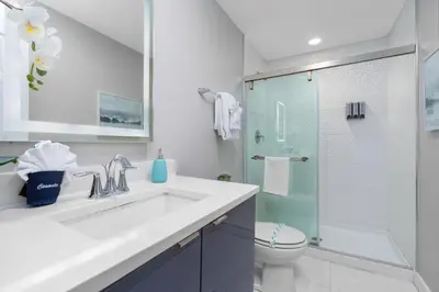 a bathroom with a sink and a glass shower at Star Wars and Frozen, Pool, 10 min to Disney in Kissimmee