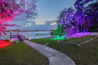 a park with a view of the water with purple lights at 4 Rooms, Lake, Pool, Hot Tub, Putt-Putt in Orlando