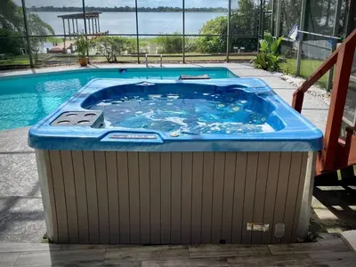 a large hot tub in front of a swimming pool at 4 Rooms, Lake, Pool, Hot Tub, Putt-Putt in Orlando